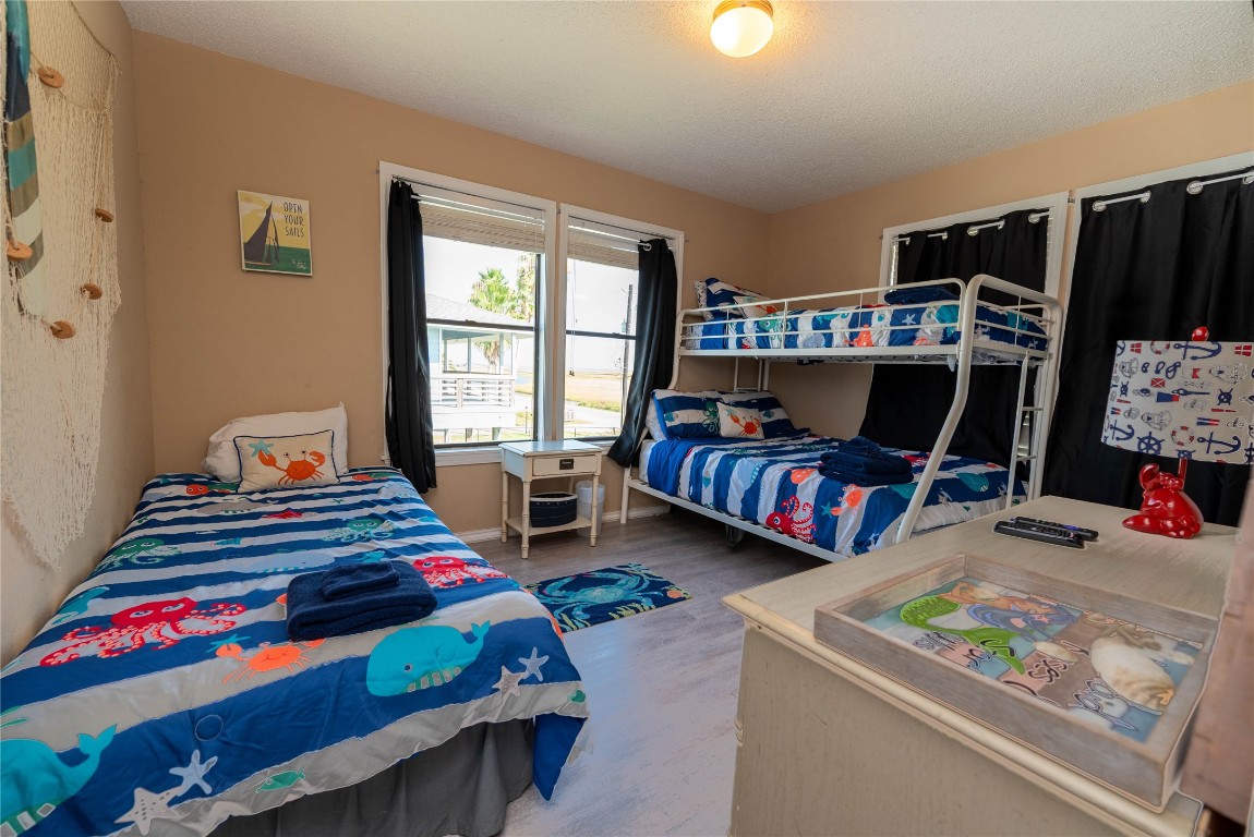 4729 Jolly Roger Road Jamaica Beach, TX 77554 - Photo 31 of 45 a bedroom with bed and a large window