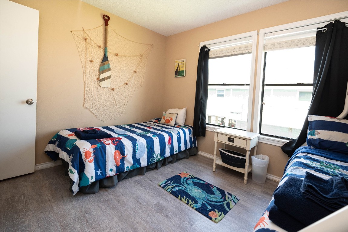 4729 Jolly Roger Road Jamaica Beach, TX 77554 - Photo 32 of 45 a bedroom with a bed couch and a window