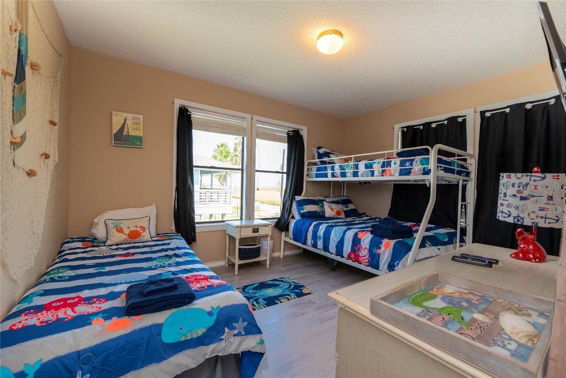 4729 Jolly Roger Road Jamaica Beach, TX 77554 - Photo 33 of 45 a bedroom with a bed and a window