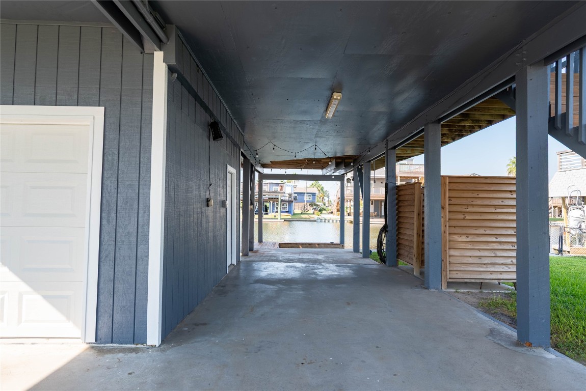 4729 Jolly Roger Road Jamaica Beach, TX 77554 - Photo 40 of 45 a view of a hallway with an empty room and a window