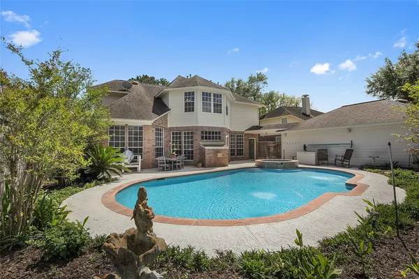 a view of a house with swimming pool and porch