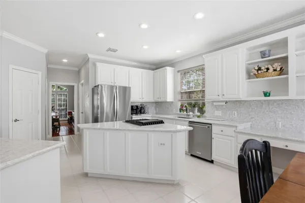 a kitchen with stainless steel appliances granite countertop a refrigerator sink and stove