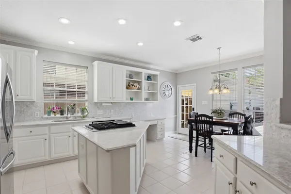 a kitchen with granite countertop sink cabinets and stainless steel appliances