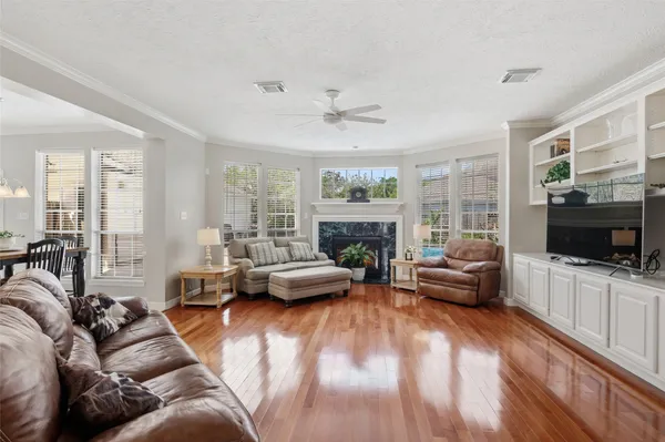 a living room with furniture a flat screen tv and a fireplace