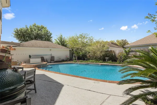 a view of a house with pool and chairs