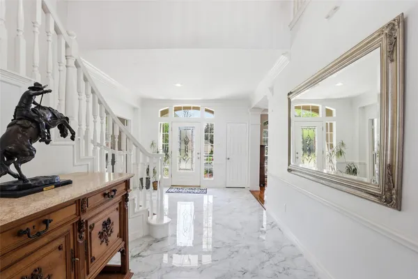 a view of an entryway with wooden floor and windows