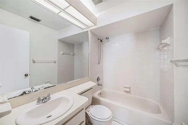 a bathroom with a toilet a sink and bathtub