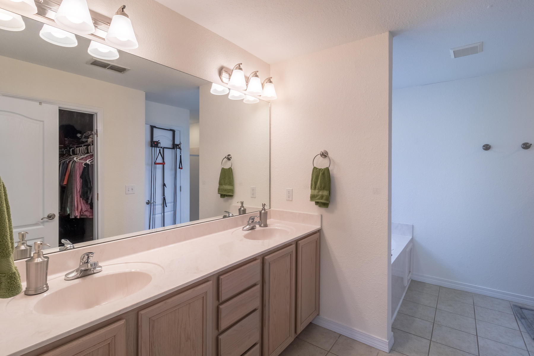 86 Red Maple Court Santa Rosa Beach, FL 32459 - Photo 22 of 32 a bathroom with a double vanity sink and a mirror