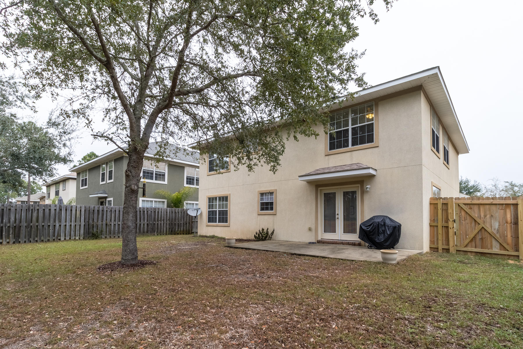 86 Red Maple Court Santa Rosa Beach, FL 32459 - Photo 5 of 32 a view of a house with backyard and a tree