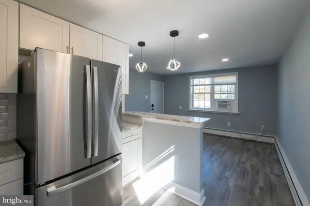 a kitchen with stainless steel appliances a refrigerator and a stove