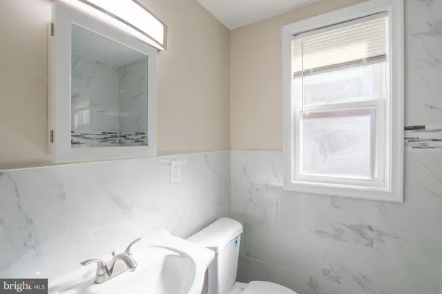 a white toilet sitting next to a window