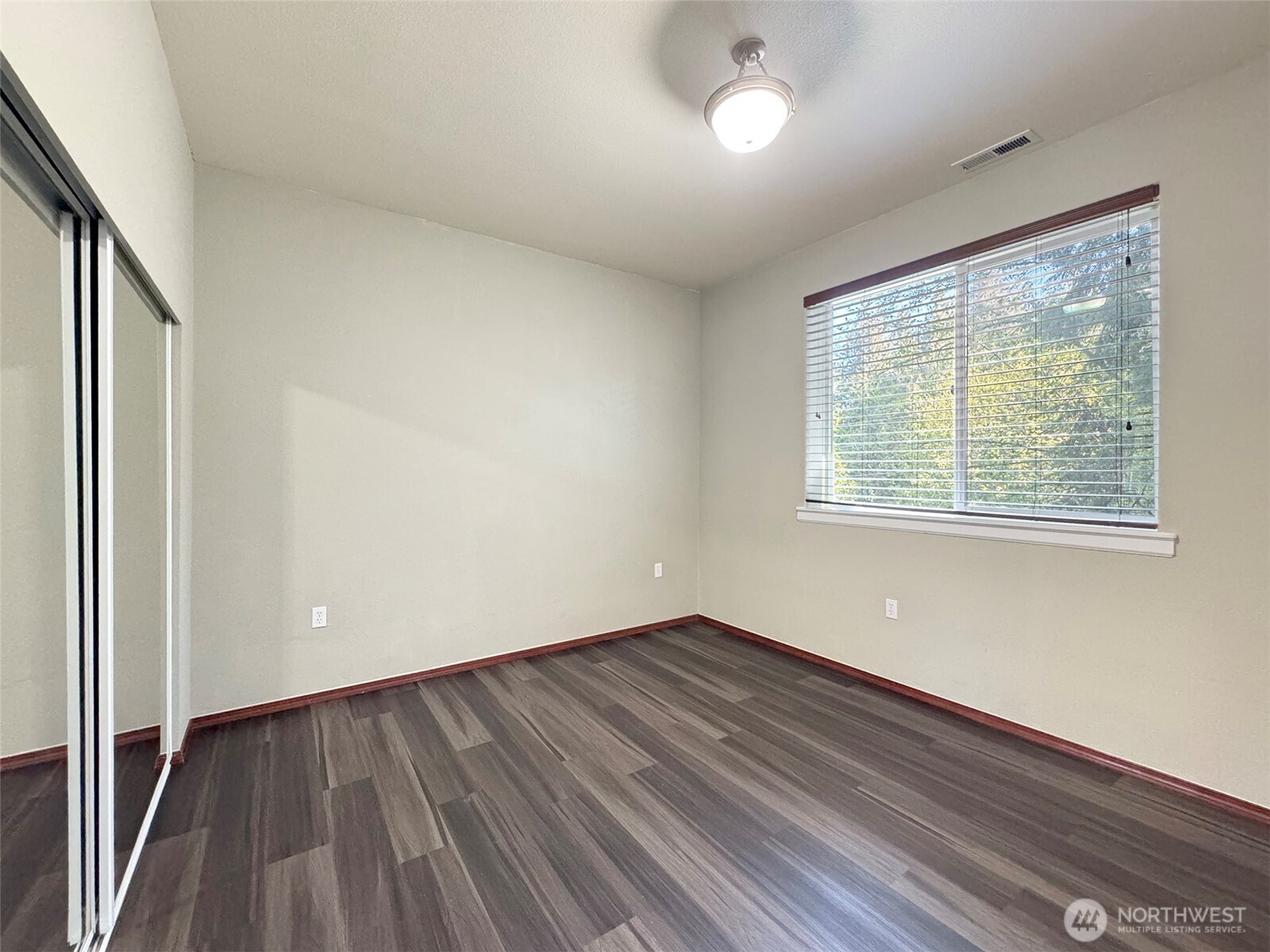 60 Alderwood Drive Sequim, WA 98382 - Photo 34 of 40 an empty room with wooden floor and windows