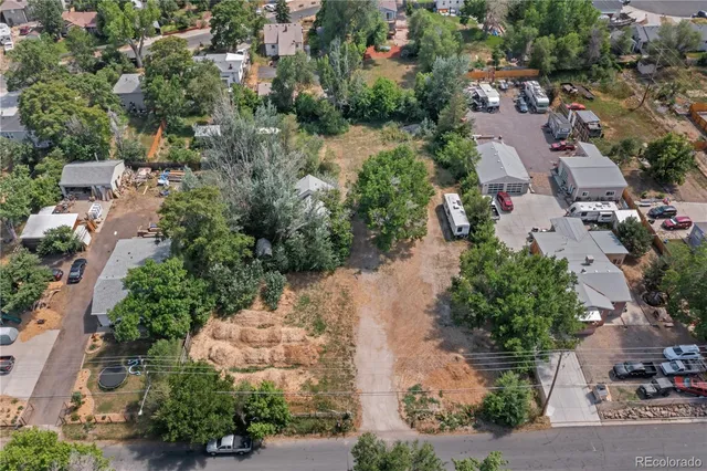 an aerial view of a houses with yard