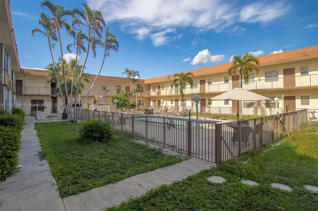 a view of a house with a yard and plants