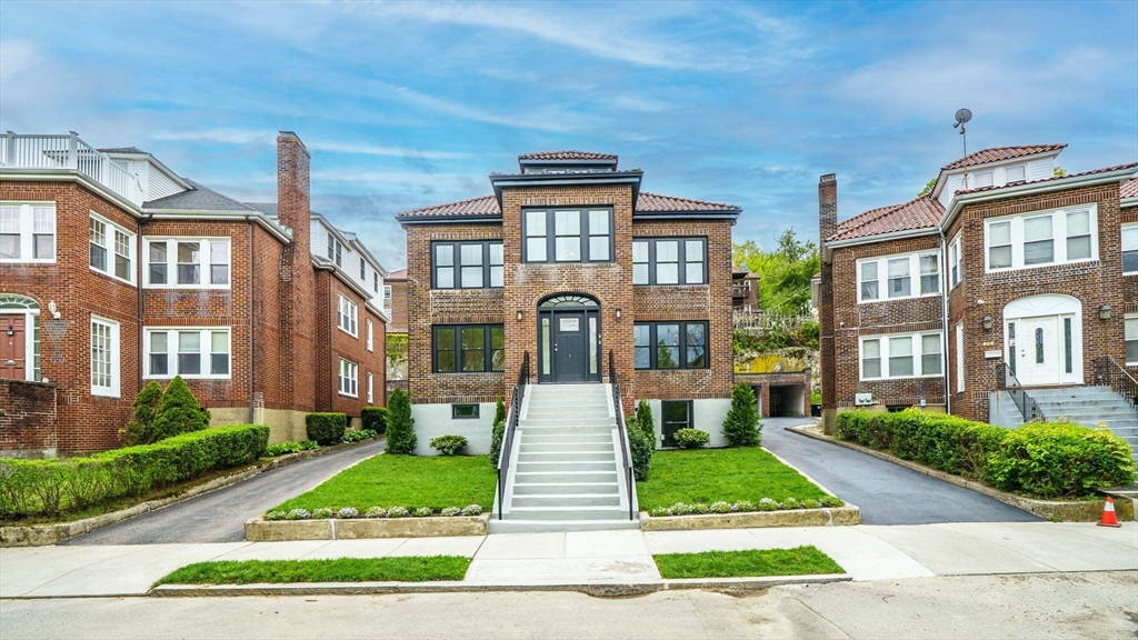 140 Columbia Street, Unit 1 Brookline, MA 02446 - Photo 1 of 41 a front view of a brick building