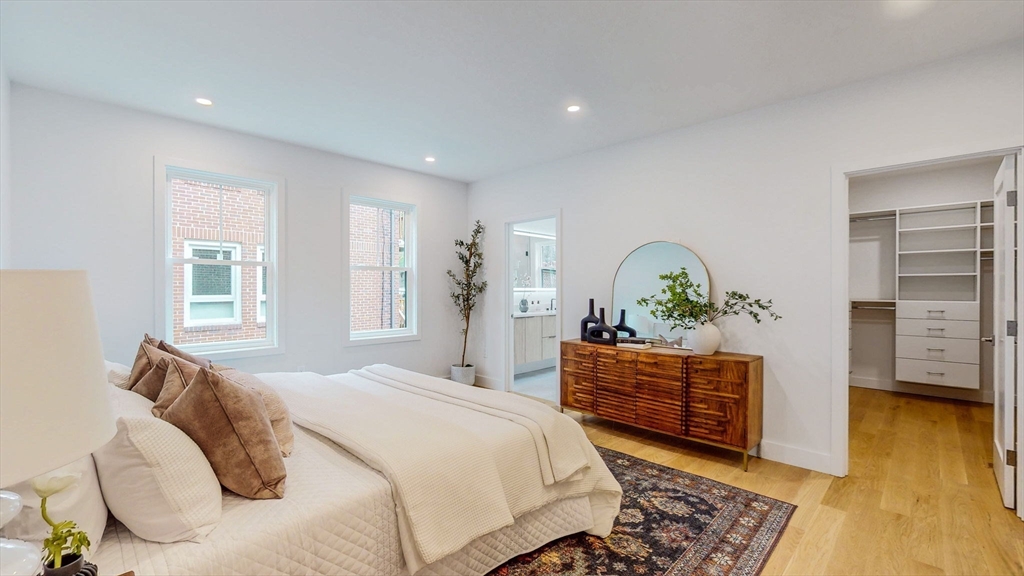 140 Columbia Street, Unit 1 Brookline, MA 02446 - Photo 14 of 41 a bedroom with a bed and a dresser