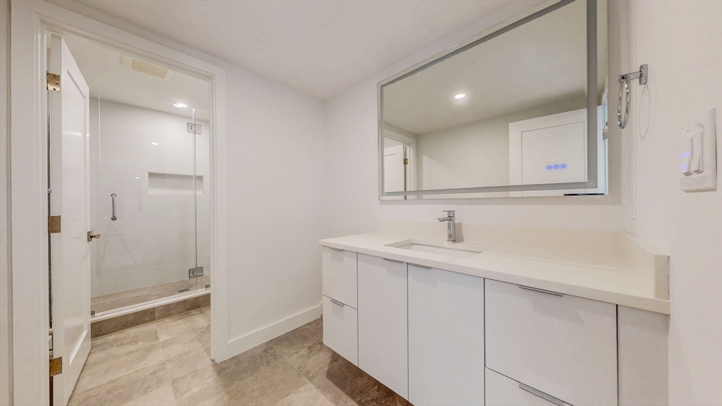 140 Columbia Street, Unit 1 Brookline, MA 02446 - Photo 32 of 41 a bathroom with a sink and a mirror