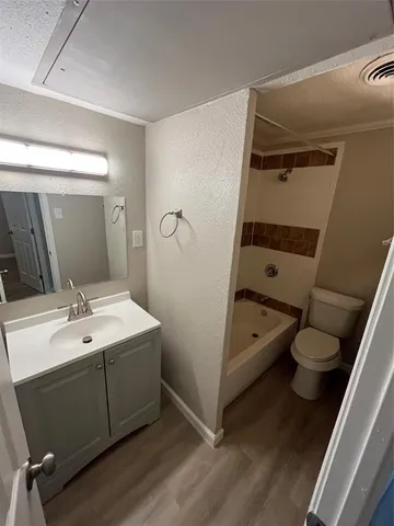 a bathroom with a sink a toilet and tub