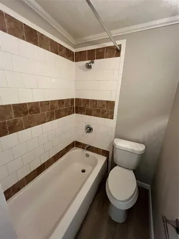 a bathroom with a toilet and shower