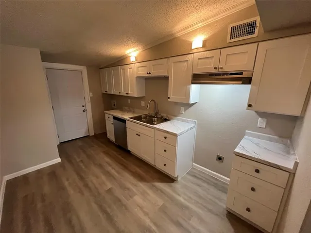 a kitchen with stainless steel appliances granite countertop a sink stove and cabinets