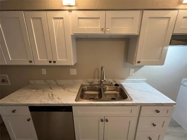 a kitchen with a sink and cabinets