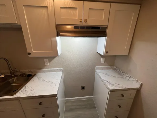a kitchen with a sink and cabinets