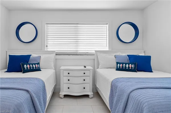 a bedroom with a bed a closet and a window