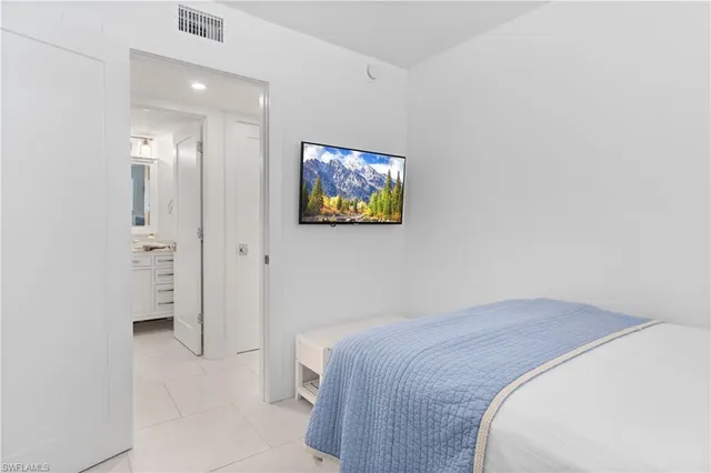 a bedroom with a bed and a painting on the wall