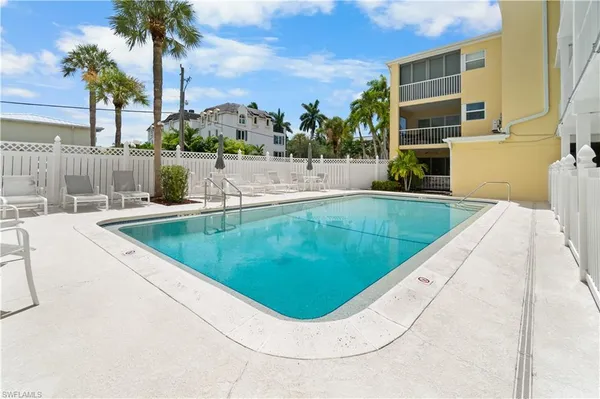 swimming pool view with a garden space