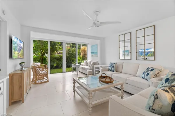 a living room with furniture and large windows