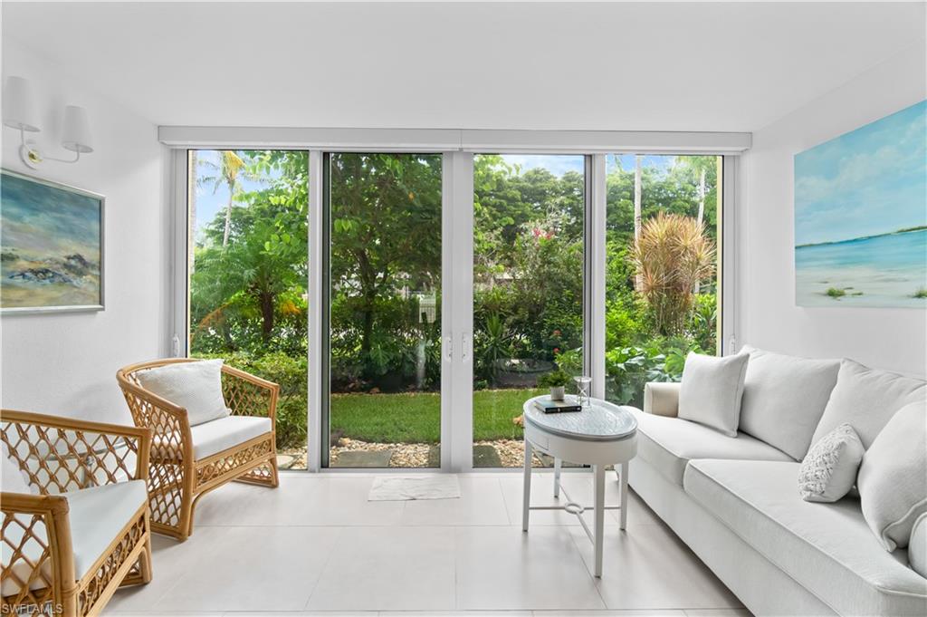 900 8th Avenue South, Unit 105 Naples, FL 34102 - Photo 3 of 20 a living room with furniture and a large window