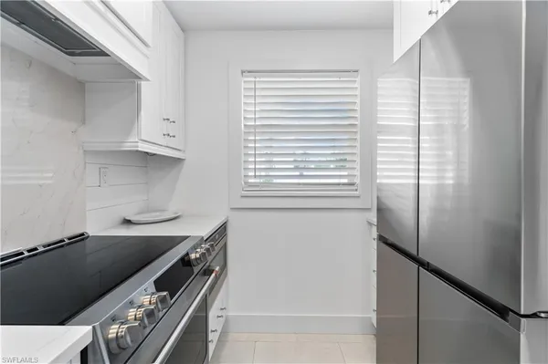 a kitchen with stainless steel appliances a refrigerator and a stove