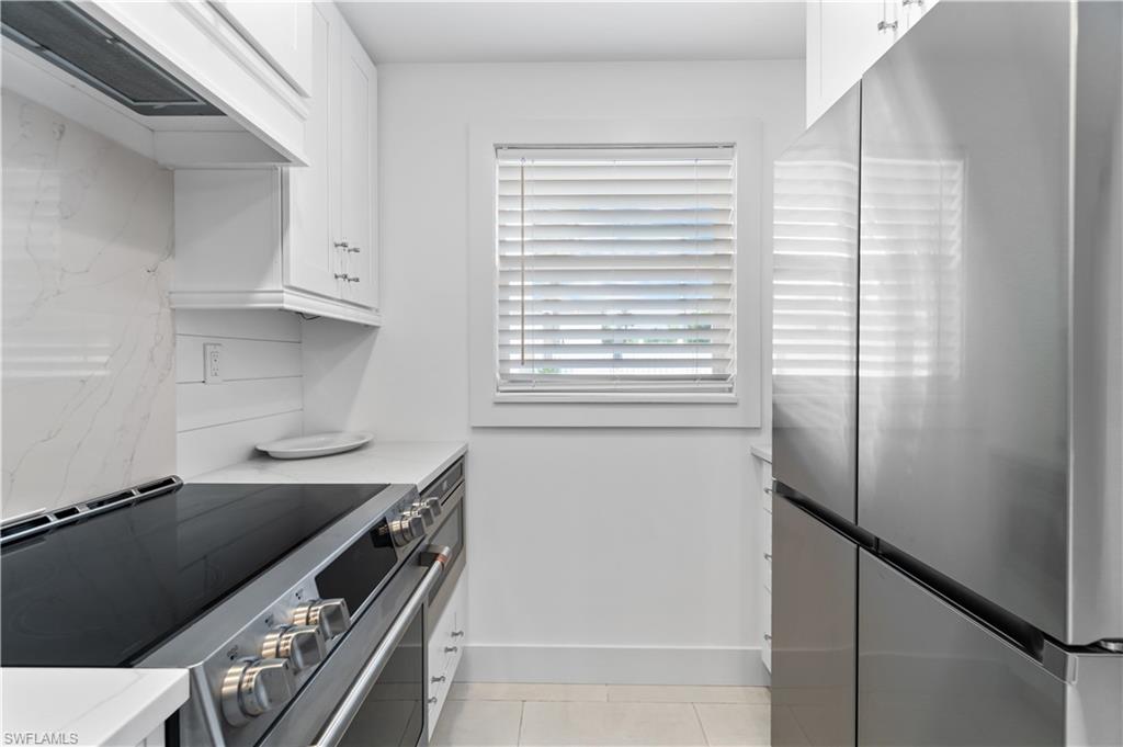 900 8th Avenue South, Unit 105 Naples, FL 34102 - Photo 9 of 20 a kitchen with stainless steel appliances a refrigerator and a stove
