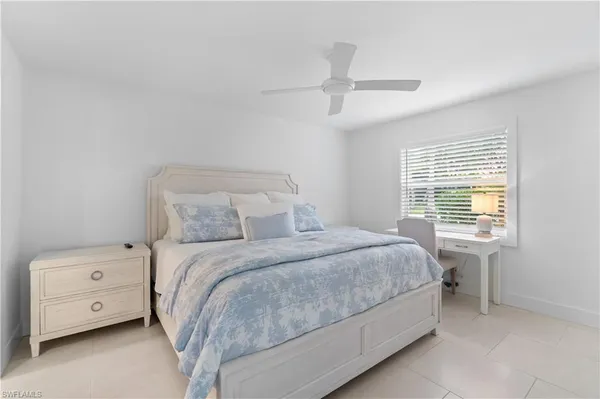 a bedroom with a bed and a tv