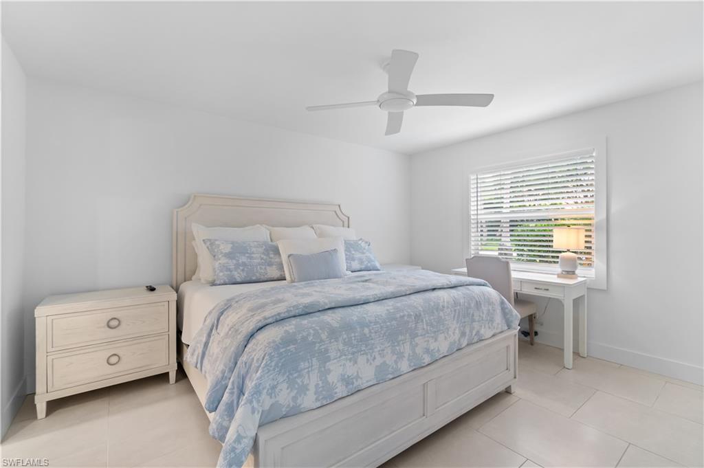 900 8th Avenue South, Unit 105 Naples, FL 34102 - Photo 10 of 20 a bedroom with a bed and a tv