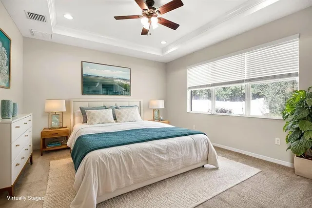 an empty room with window and ceiling fan