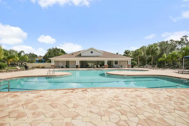 a view of swimming pool with outdoor seating and plants