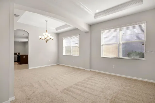 a view of a big room with chandelier and glass door