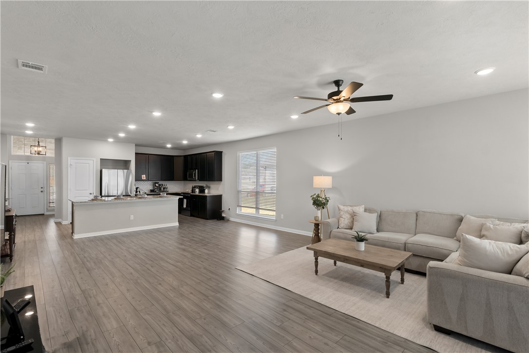 1925 Viva Road Bryan, TX 77807 - Photo 9 of 26 a living room with furniture and a wooden floor