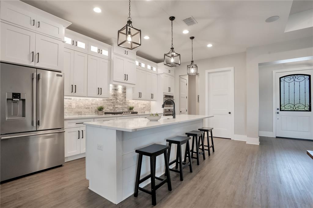 440 Palma Ceia Road Winter Haven, FL 33884 - Photo 15 of 78 a kitchen with kitchen island granite countertop a center island a sink stainless steel appliances and cabinets