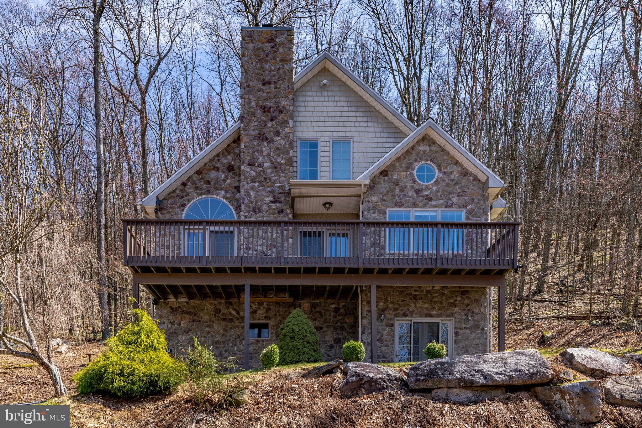 Charming stone home in serene woods.