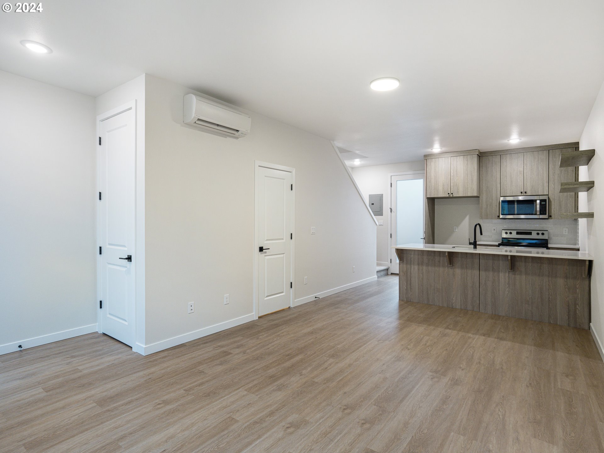 8524 North Endicott Avenue, Unit 2 Portland, OR 97217 - Photo 4 of 12 a view of kitchen with kitchen island wooden floors and stainless steel appliances
