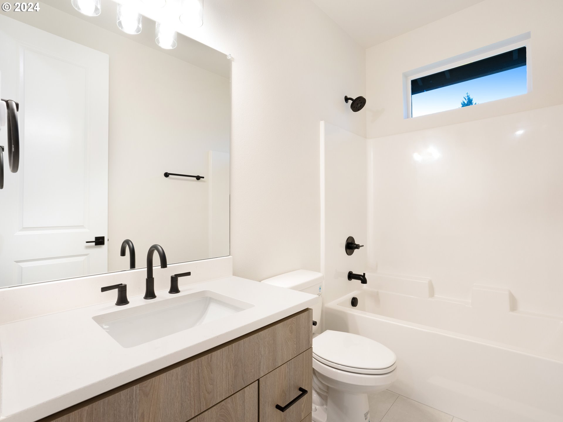 8524 North Endicott Avenue, Unit 2 Portland, OR 97217 - Photo 9 of 12 a bathroom with a sink a toilet and shower