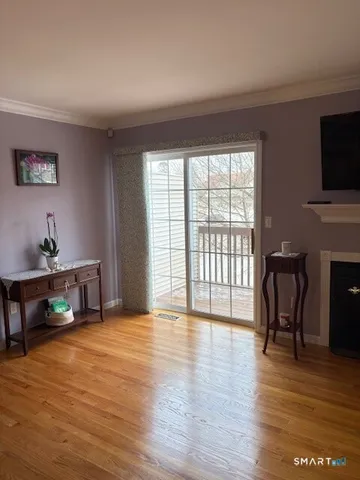 a view of livingroom with furniture flat screen tv and wooden floor