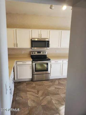 a kitchen with a stove a sink and a microwave
