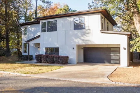 a house with swimming pool in front of it