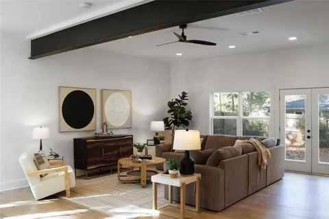 a living room with furniture fireplace and window