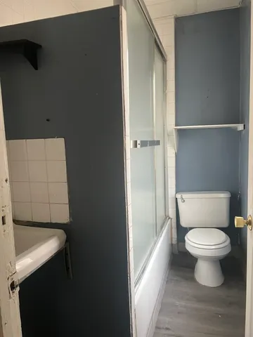 a bathroom with a toilet and a shower