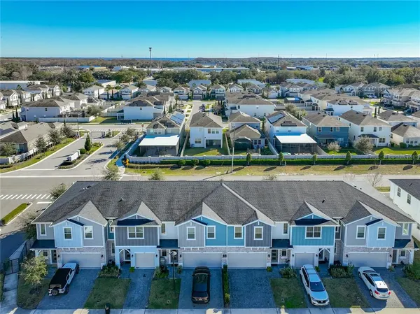 an aerial view of residential houses with outdoor space