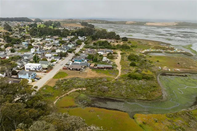 an aerial view of ocean with residential house